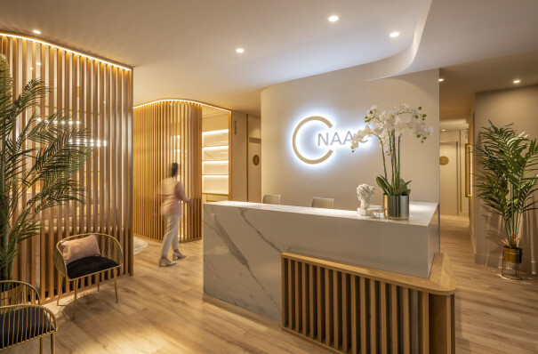Wooden lattice and monochromatic colours dictate this beauty clinic by In Out Studio in Spain