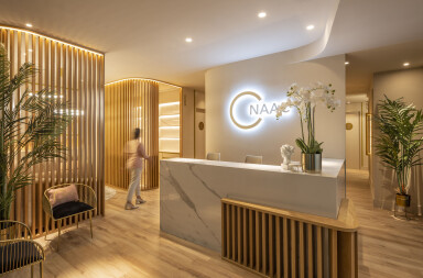 Wooden lattice and monochromatic colours dictate this beauty clinic by In Out Studio in Spain